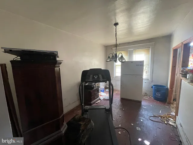 a view of entryway and hall with a wooden floor