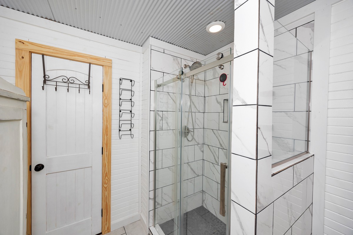 375 Kelley Road Prospect, TN 38477 - Photo 14 of 42 a bathroom with a shower and a glass door