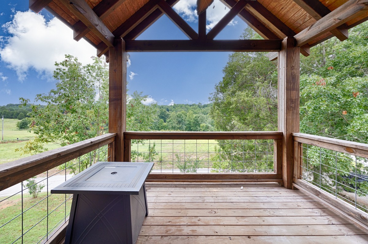 375 Kelley Road Prospect, TN 38477 - Photo 26 of 42 a view of a balcony with furniture and wooden floor