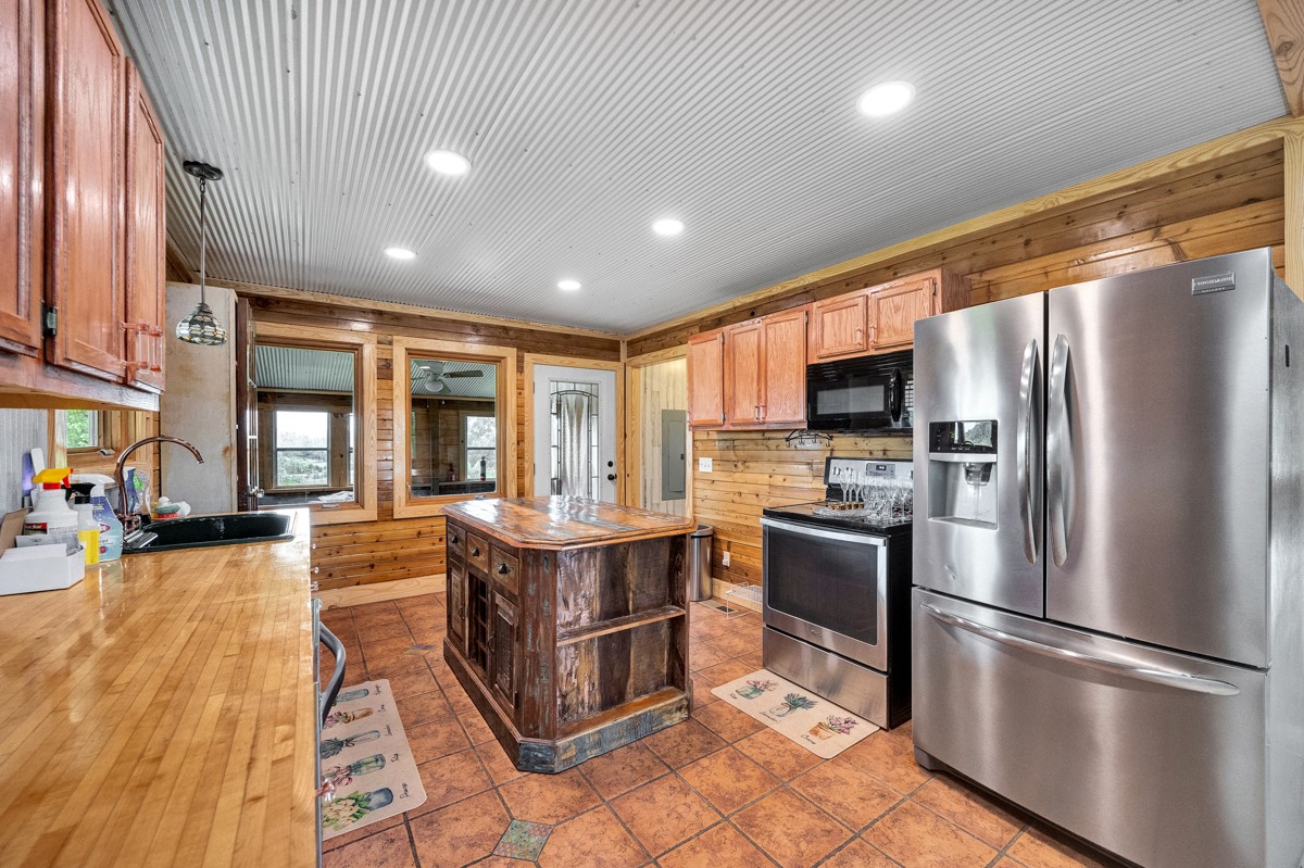375 Kelley Road Prospect, TN 38477 - Photo 9 of 42 a kitchen with stainless steel appliances granite countertop a refrigerator a sink dishwasher a stove and a refrigerator with wooden floor