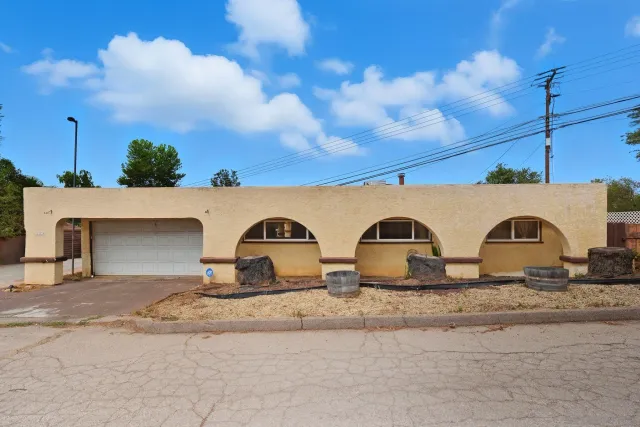 a front view of a house with garden