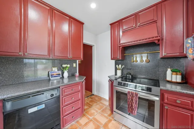 a kitchen with stainless steel appliances granite countertop a stove and a microwave