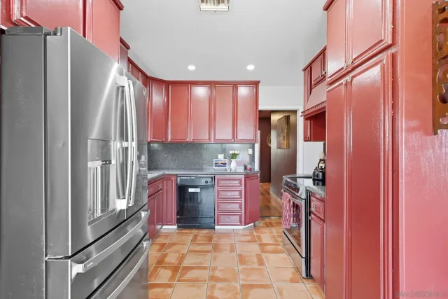 a kitchen with stainless steel appliances granite countertop a refrigerator and a stove top oven