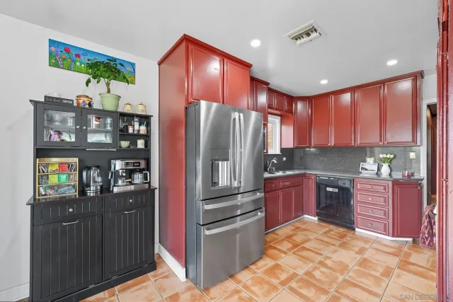 a kitchen with stainless steel appliances granite countertop a refrigerator and a stove top oven