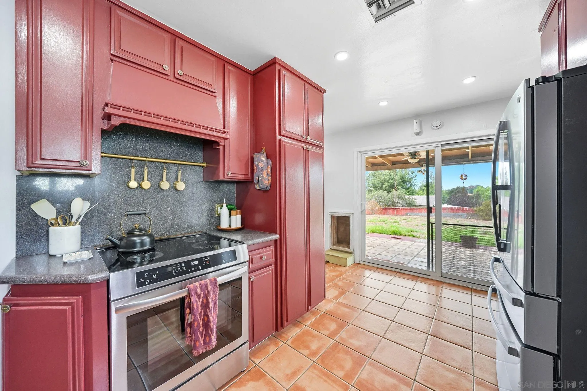 321 North Lane El Cajon, CA 92021 - Photo 16 of 44 a kitchen with stainless steel appliances granite countertop a stove a sink and a microwave
