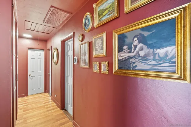 a view of a hallway with a painting on the wall