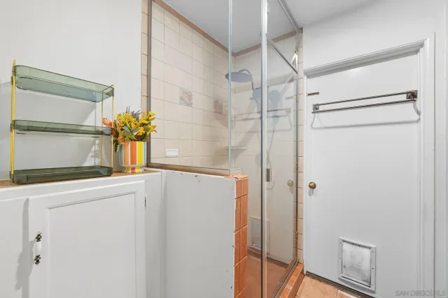 a bathroom with a granite countertop shower and a sink