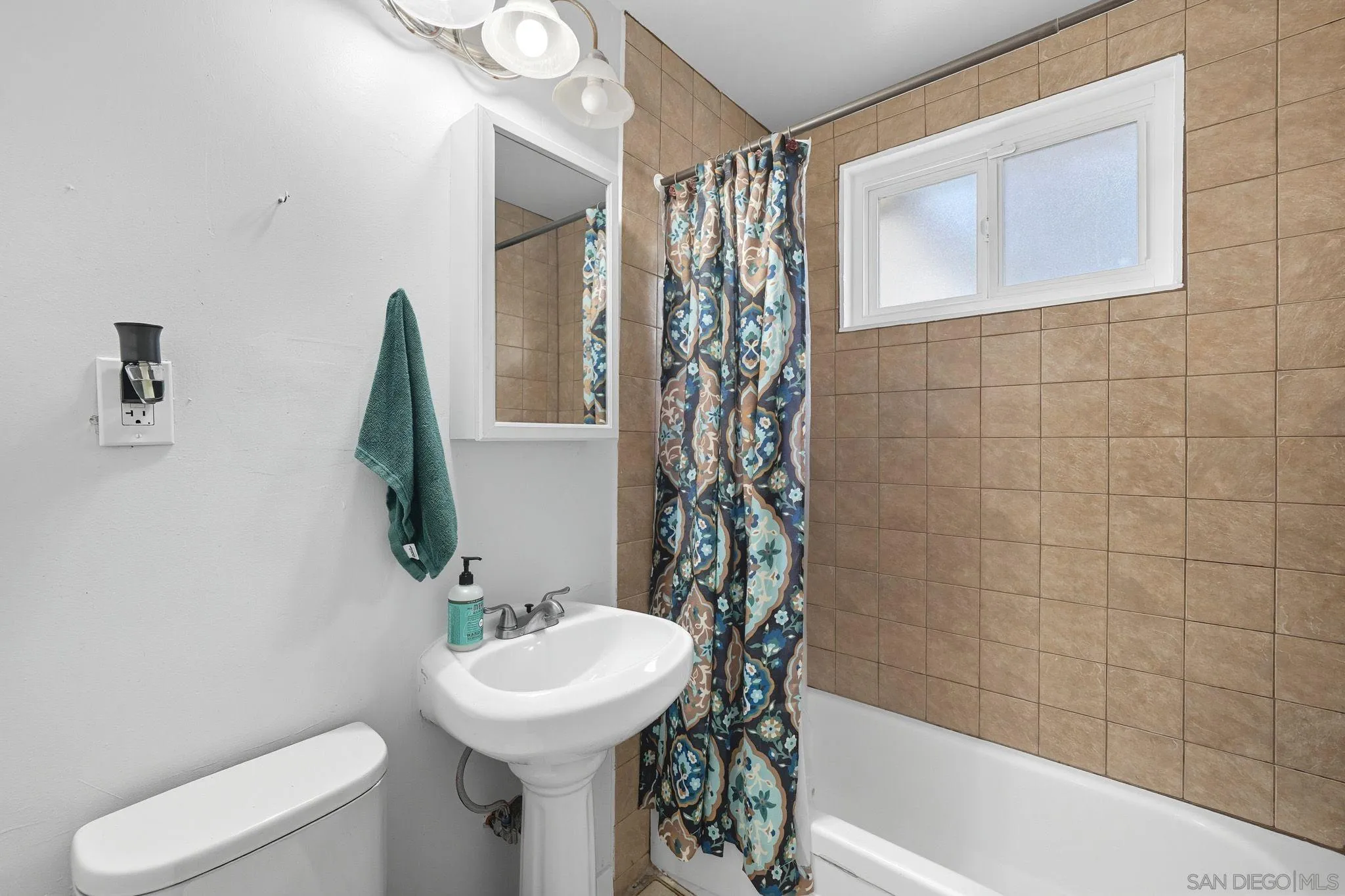 321 North Lane El Cajon, CA 92021 - Photo 22 of 44 a bathroom with a sink toilet and shower