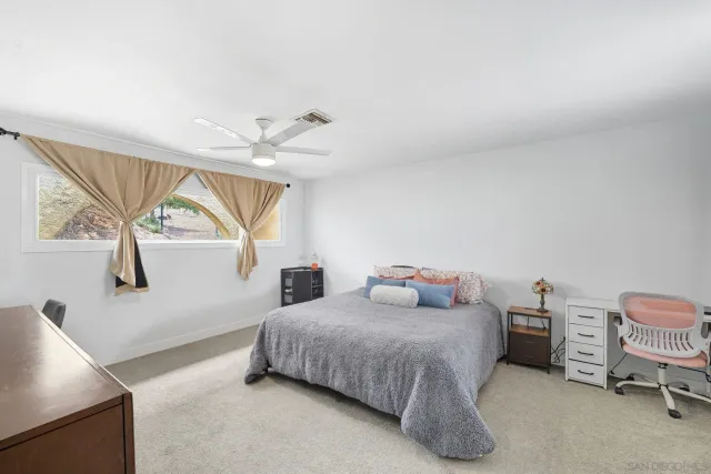 a bedroom with a bed dresser and a window