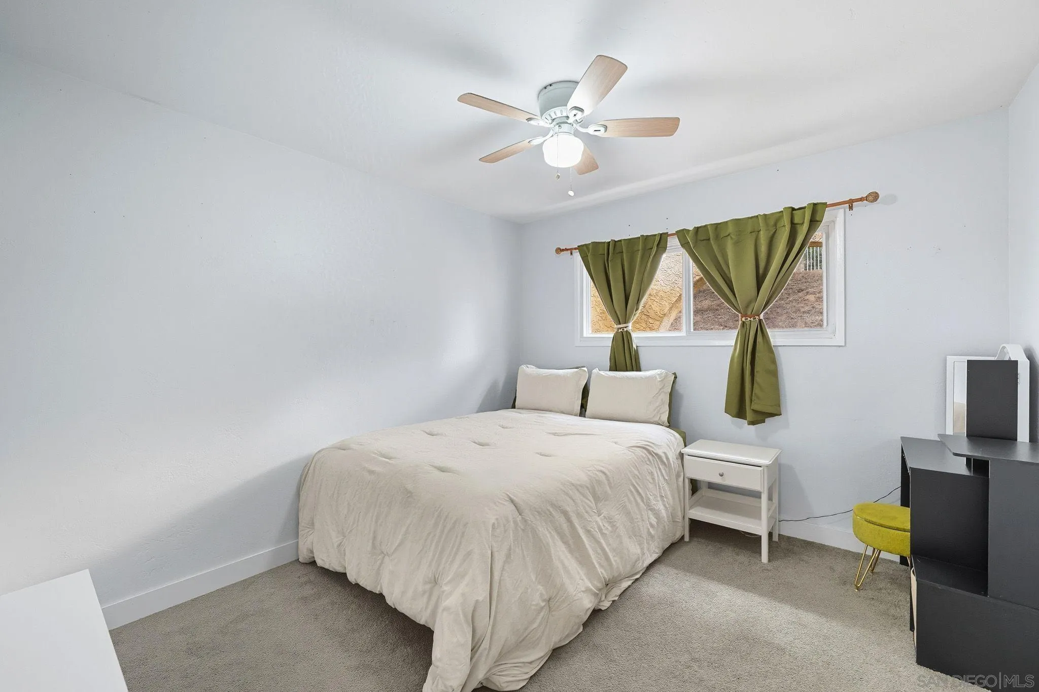 321 North Lane El Cajon, CA 92021 - Photo 26 of 44 a bedroom with a bed and a chandelier