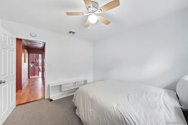 a bedroom with a bed and a ceiling fan