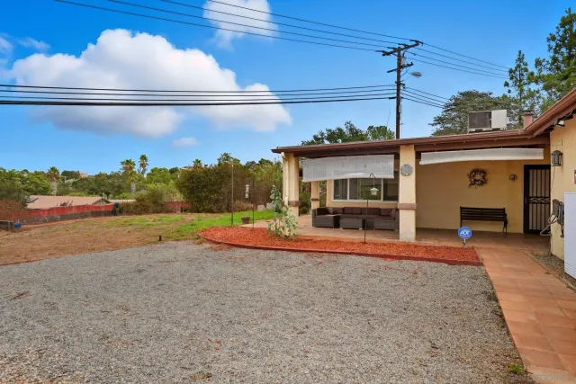 a view of a house with backyard and porch