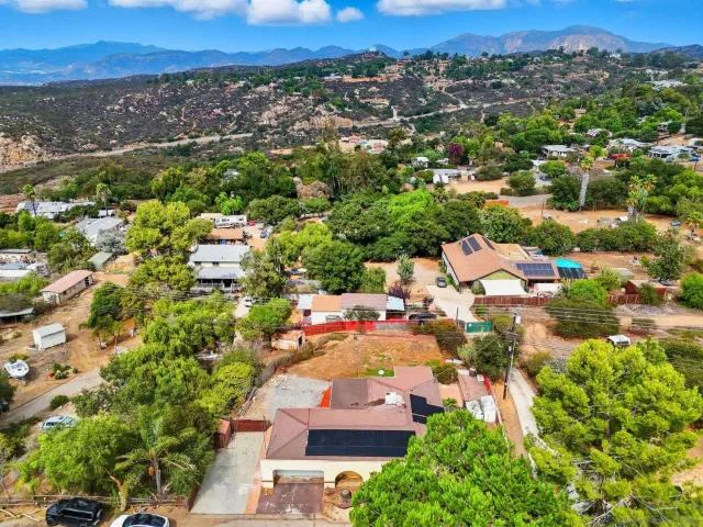 an aerial view of residential houses with city view