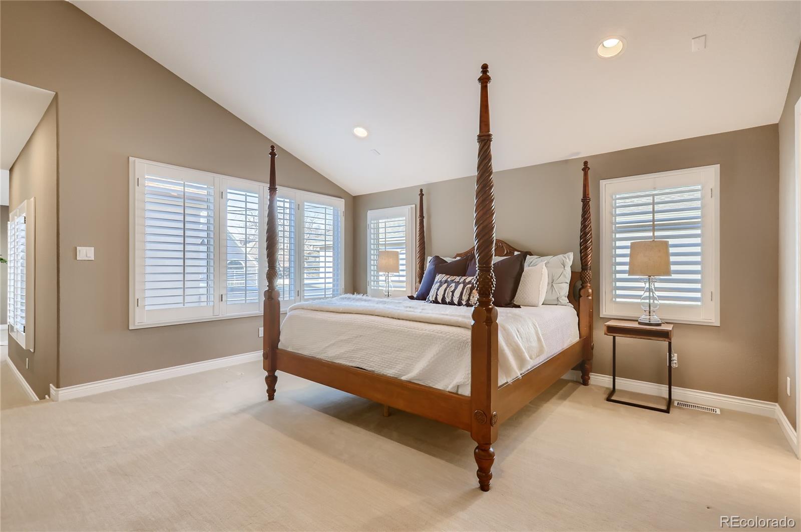 445 Jackson Street Denver, CO 80206 - Photo 14 of 29 a bed sitting in a spacious bedroom next to a window