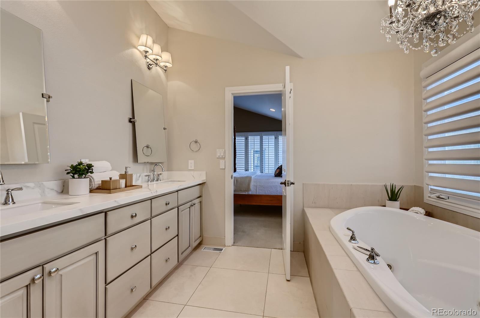 445 Jackson Street Denver, CO 80206 - Photo 17 of 29 a en suite spacious bathroom with a tub double sink and mirror