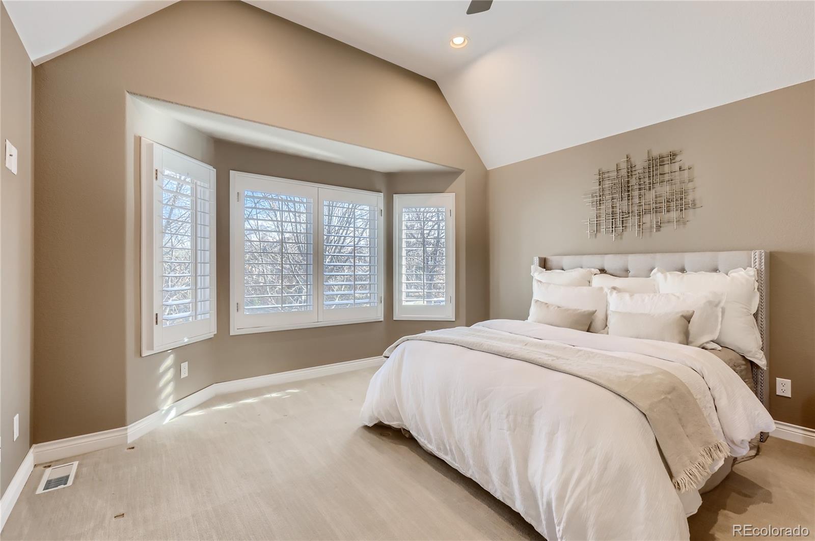 445 Jackson Street Denver, CO 80206 - Photo 19 of 29 a large bed sitting in a bedroom next to a window