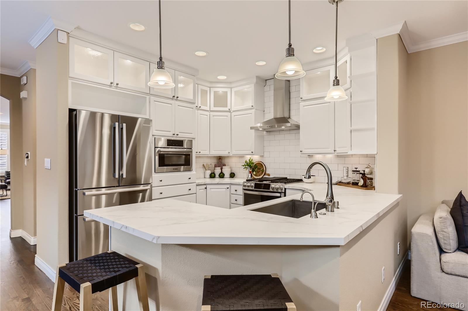 445 Jackson Street Denver, CO 80206 - Photo 6 of 29 a kitchen with kitchen island a sink appliances and cabinets