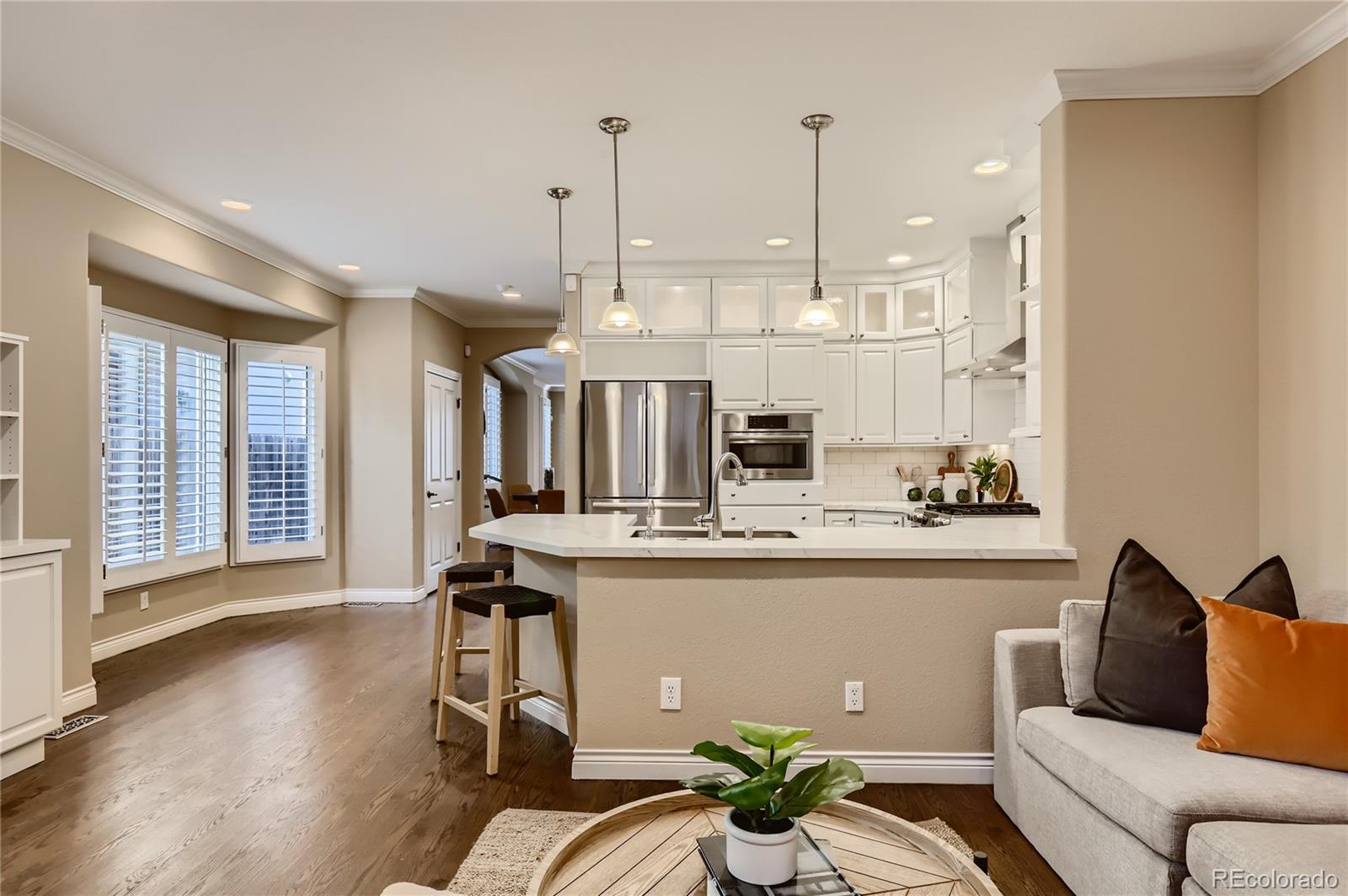 445 Jackson Street Denver, CO 80206 - Photo 7 of 29 a living room with stainless steel appliances kitchen island granite countertop furniture and a large window