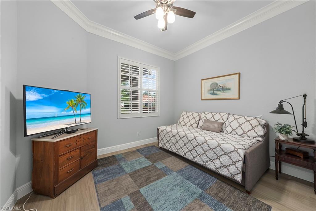 3653 Periwinkle Way, Unit 127 Naples, FL 34114 - Photo 11 of 44 a living room with furniture and a flat screen tv