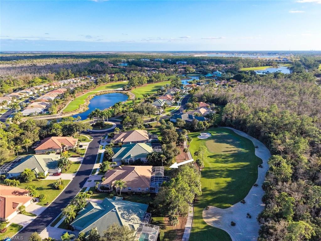 3653 Periwinkle Way, Unit 127 Naples, FL 34114 - Photo 2 of 44 a view of a swimming pool and an ocean