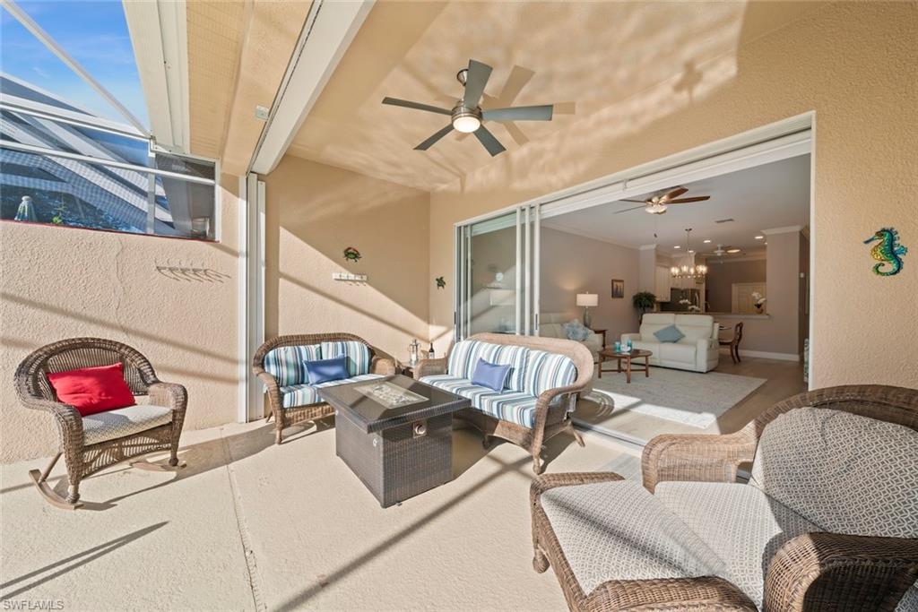 3653 Periwinkle Way, Unit 127 Naples, FL 34114 - Photo 23 of 44 a living room with furniture and a chandelier