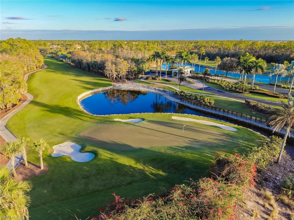 3653 Periwinkle Way, Unit 127 Naples, FL 34114 - Photo 29 of 44 a view of a swimming pool with an ocean view