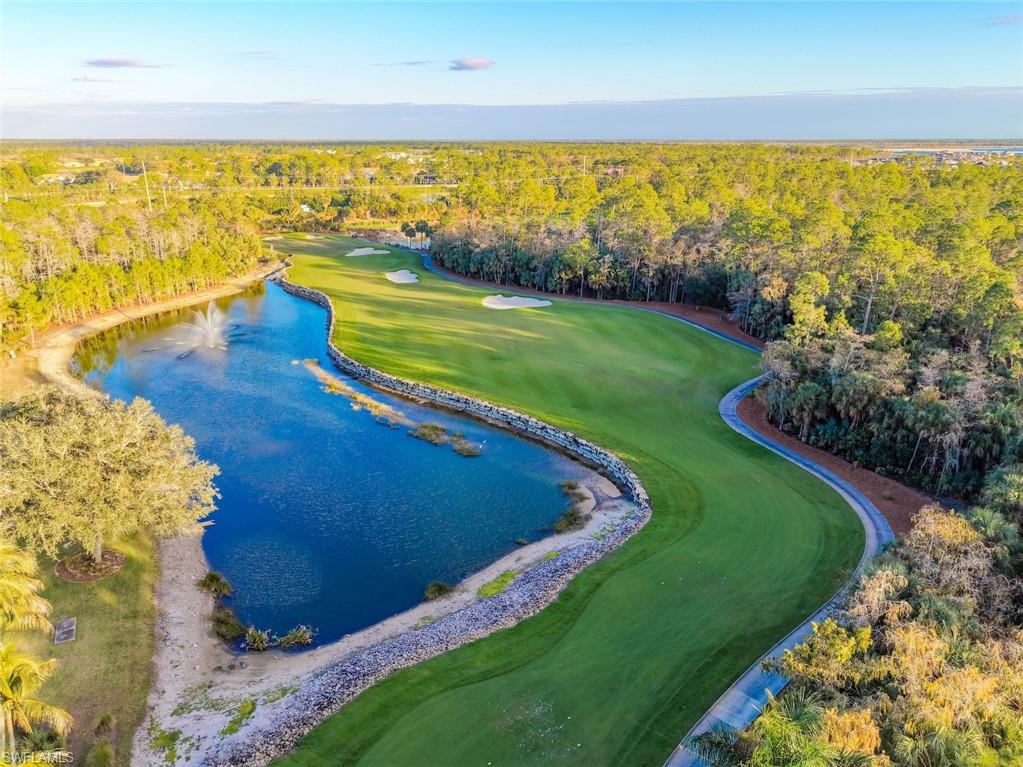 3653 Periwinkle Way, Unit 127 Naples, FL 34114 - Photo 31 of 44 a view of a lake with a beach