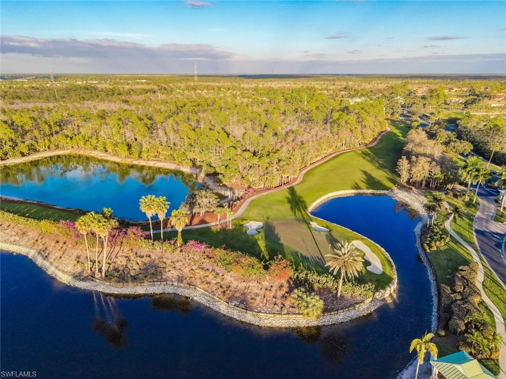 3653 Periwinkle Way, Unit 127 Naples, FL 34114 - Photo 32 of 44 a view of a lake from a swimming pool