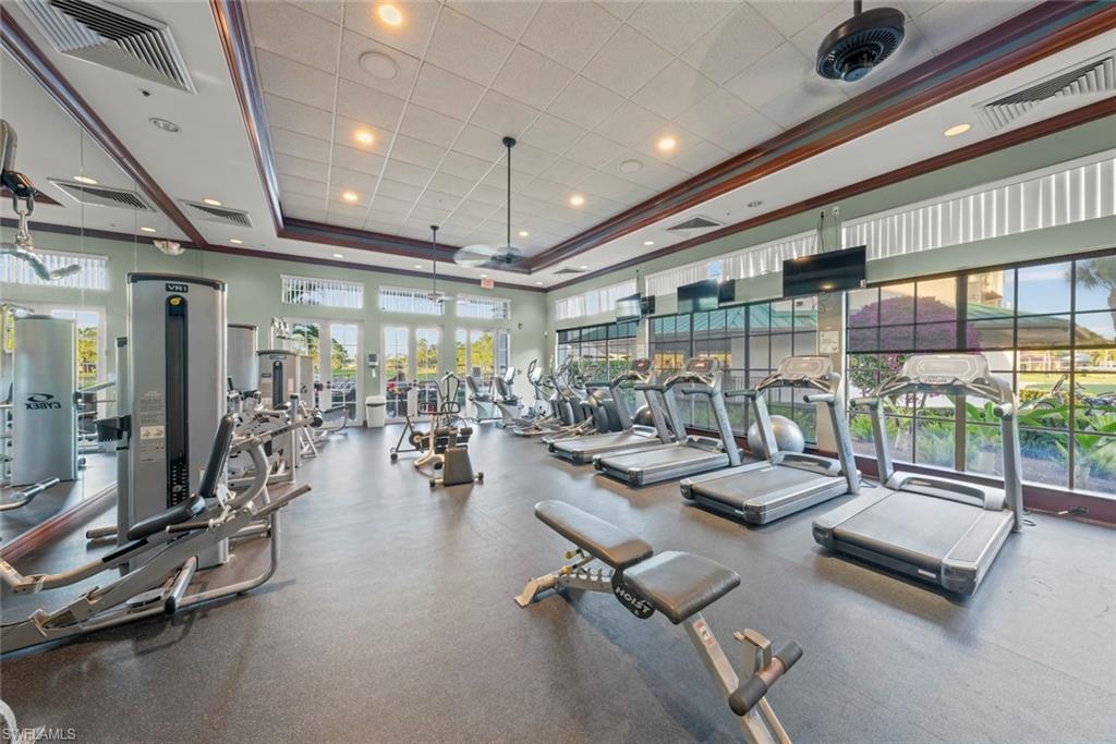 3653 Periwinkle Way, Unit 127 Naples, FL 34114 - Photo 40 of 44 a room with gym equipment and a large window
