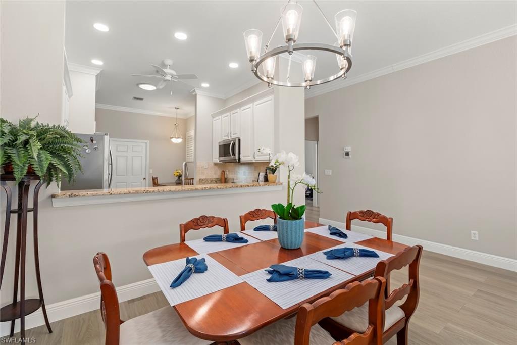 3653 Periwinkle Way, Unit 127 Naples, FL 34114 - Photo 4 of 44 a dining room with furniture and a potted plant