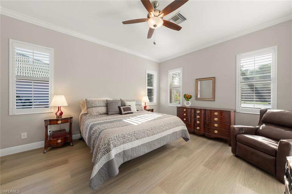 3653 Periwinkle Way, Unit 127 Naples, FL 34114 - Photo 6 of 44 a bedroom with a bed and furniture