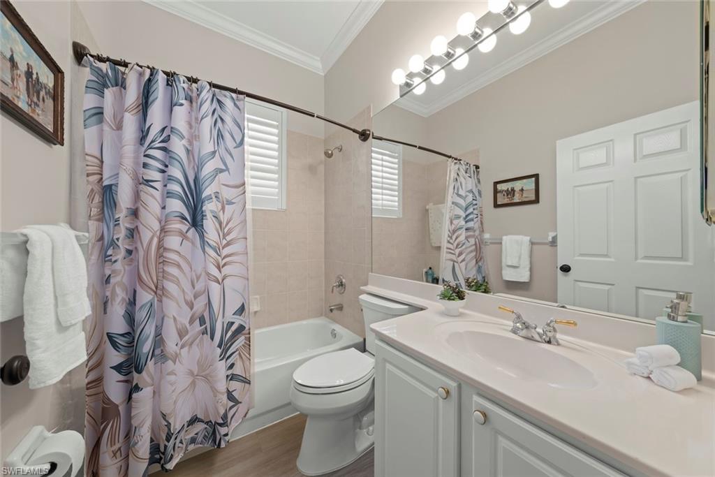 3653 Periwinkle Way, Unit 127 Naples, FL 34114 - Photo 10 of 44 a bathroom with a sink a toilet and shower