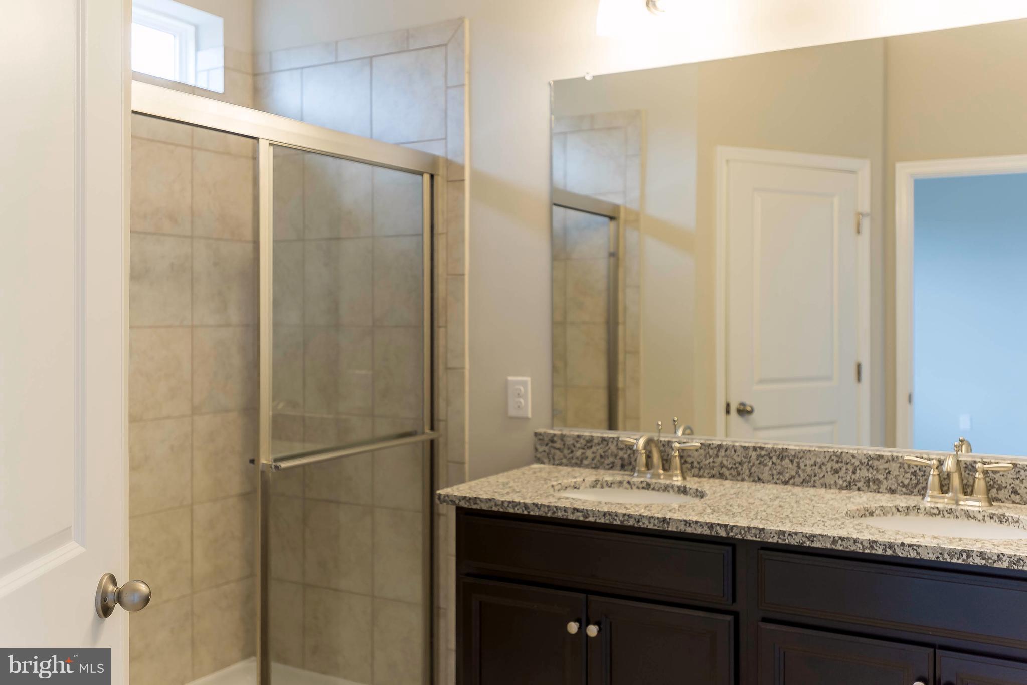 4609 Cambria Road Frederick, MD 21703 - Photo 19 of 29 a bathroom with a granite countertop sink and a mirror