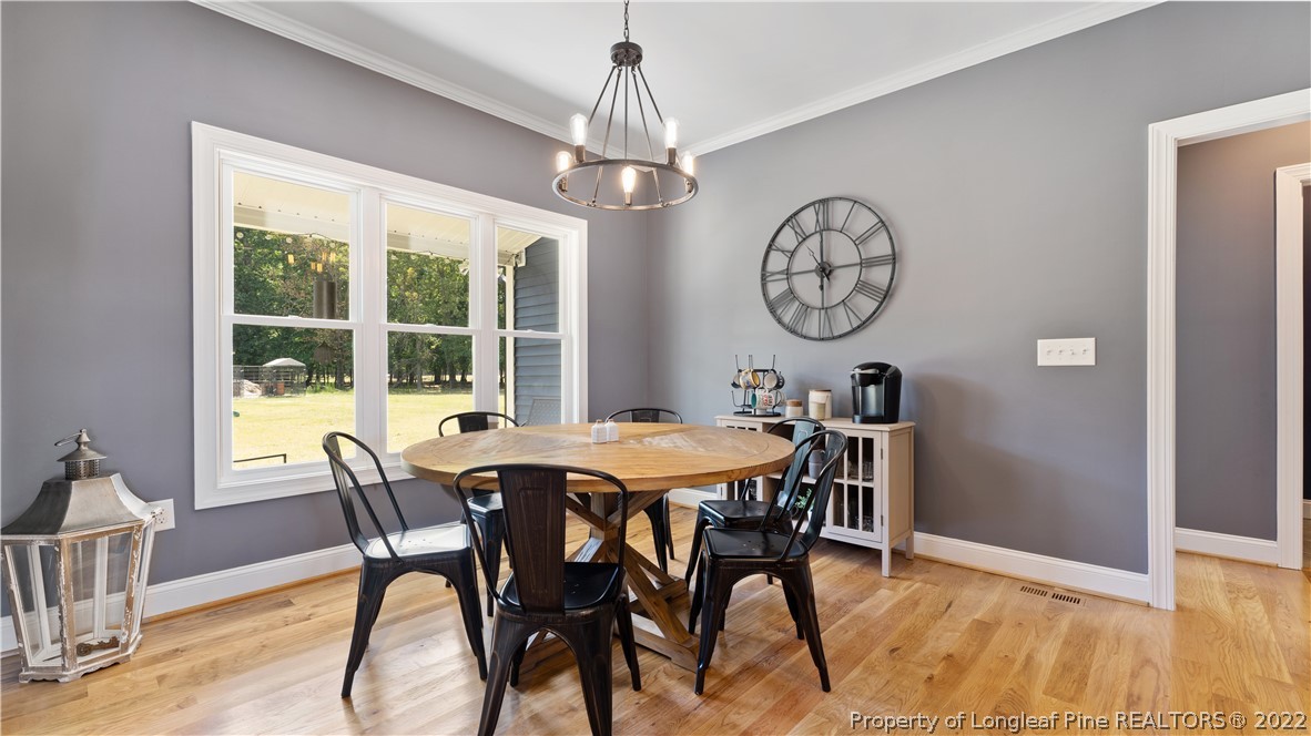 430 Mingo Church Road Dunn, NC 28334 - Photo 14 of 48 a view of a dining room with furniture window and wooden floor