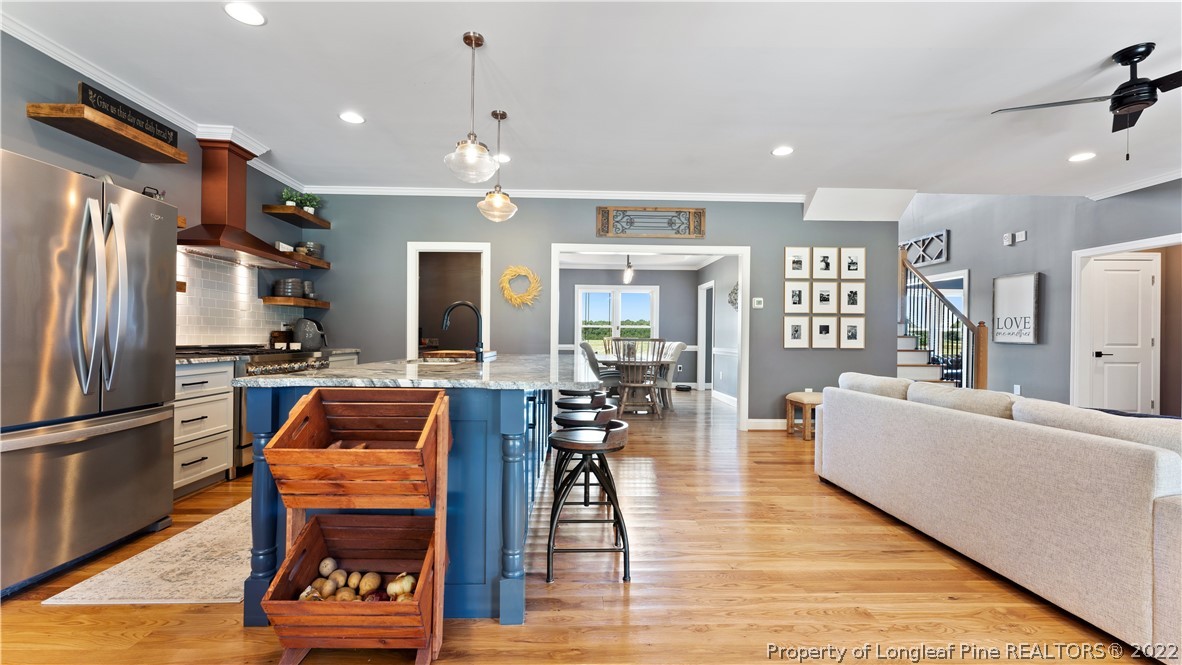 430 Mingo Church Road Dunn, NC 28334 - Photo 15 of 48 a living room with furniture a wooden floor and a refrigerator