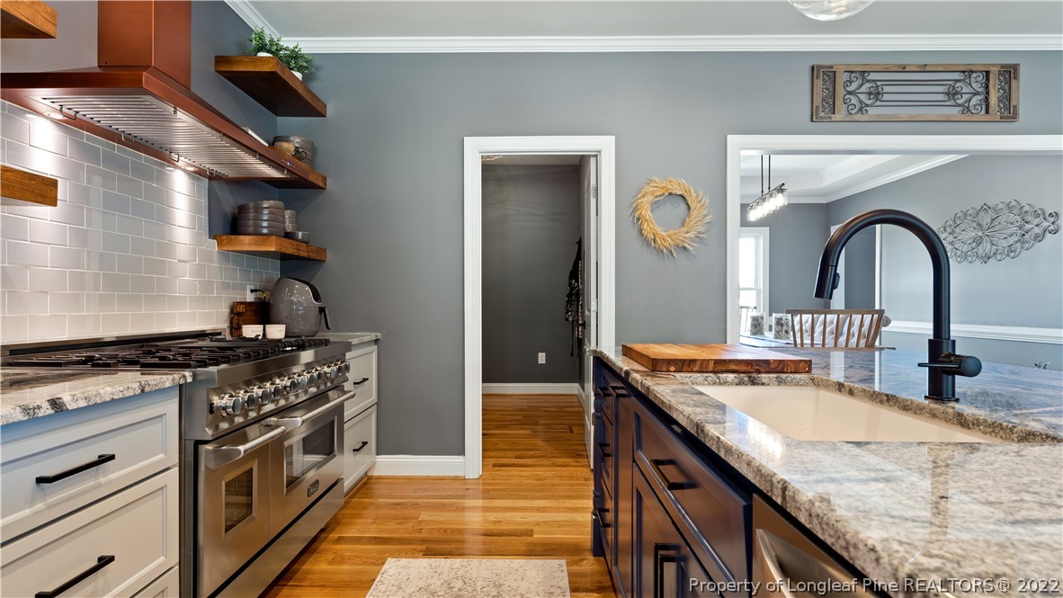 430 Mingo Church Road Dunn, NC 28334 - Photo 19 of 48 a kitchen with stainless steel appliances granite countertop a stove and a sink