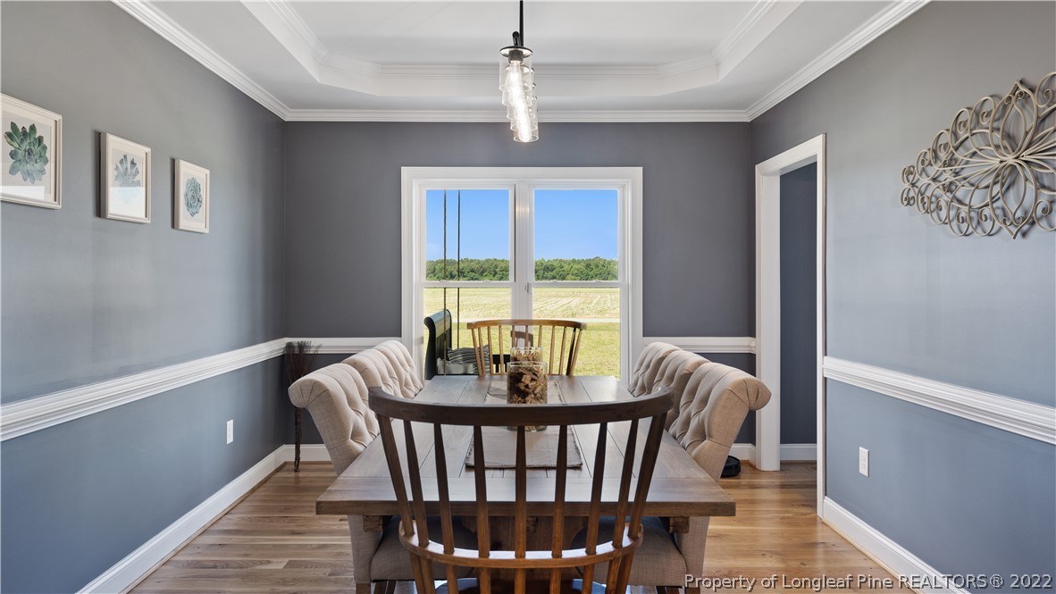 430 Mingo Church Road Dunn, NC 28334 - Photo 21 of 48 a dining room with furniture a chandelier and wooden floor