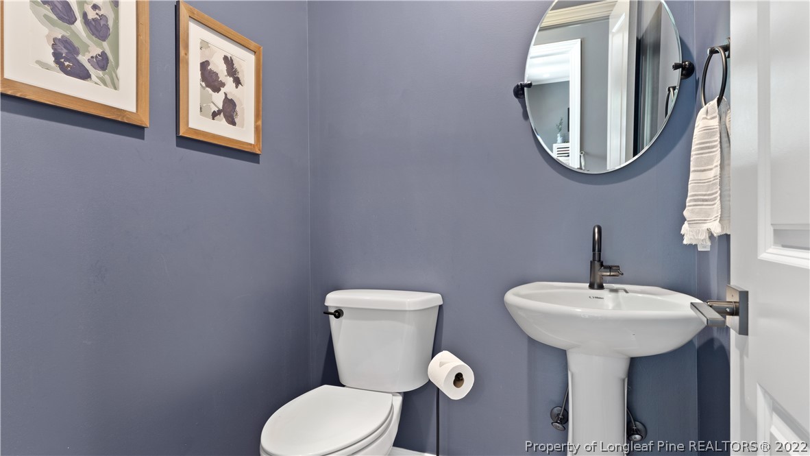 430 Mingo Church Road Dunn, NC 28334 - Photo 23 of 48 a bathroom with a toilet a sink and mirror