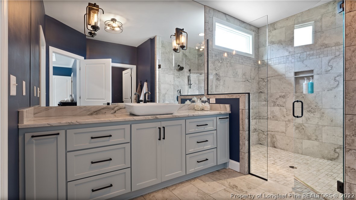 430 Mingo Church Road Dunn, NC 28334 - Photo 28 of 48 a bathroom with a granite countertop sink a mirror and a shower