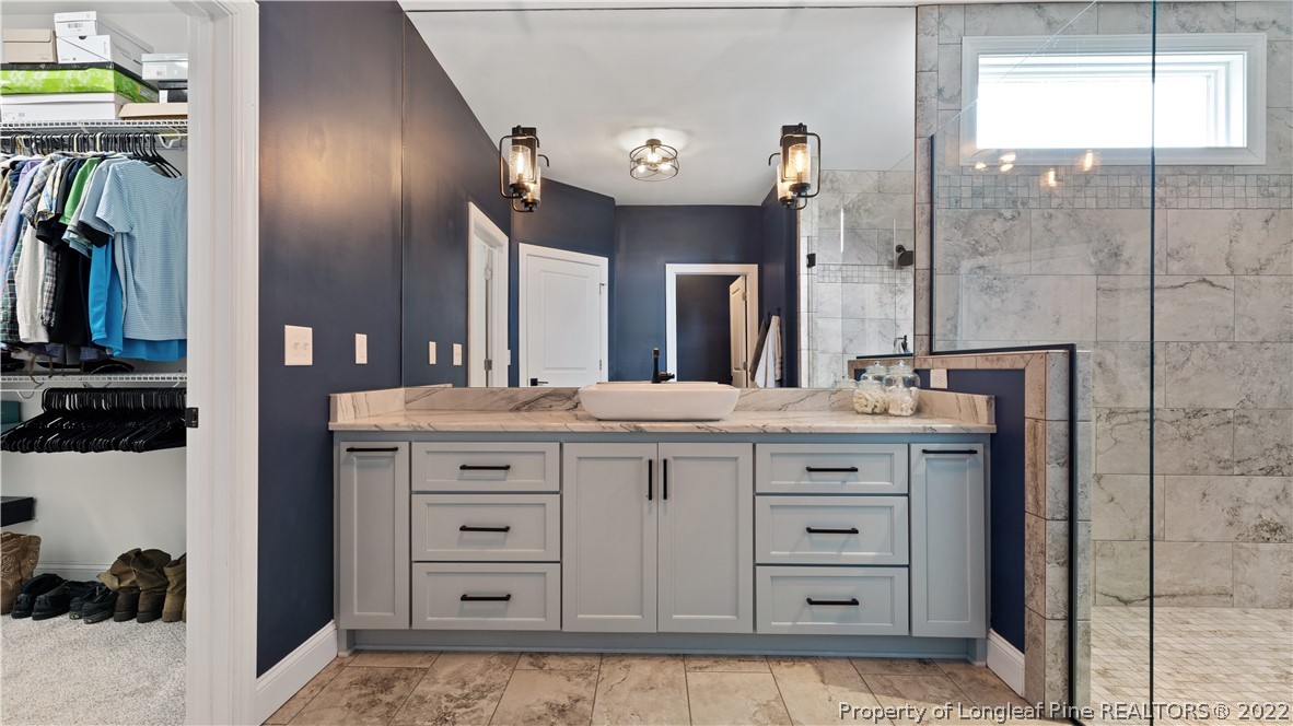430 Mingo Church Road Dunn, NC 28334 - Photo 29 of 48 a spacious bathroom with a granite countertop sink a mirror and shower