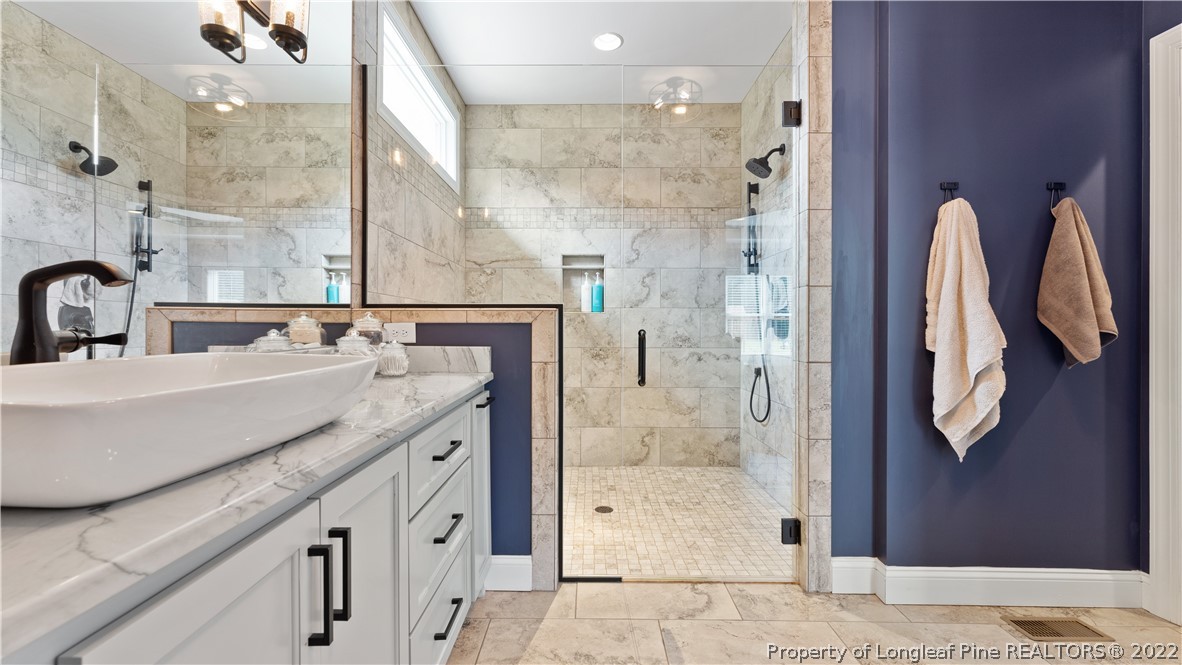 430 Mingo Church Road Dunn, NC 28334 - Photo 30 of 48 a spacious bathroom with a granite countertop shower sink and a mirror