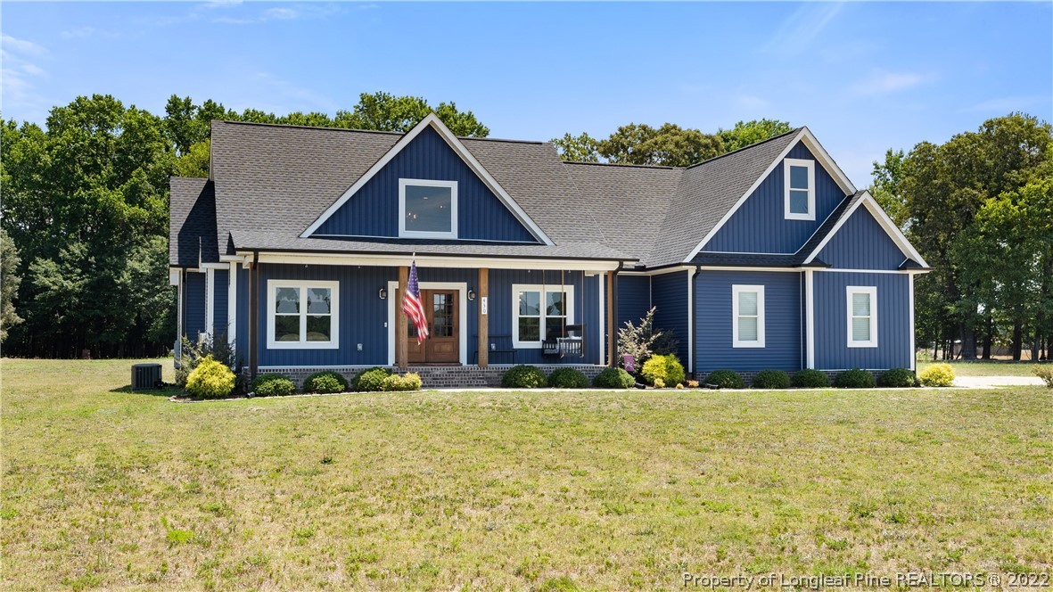 430 Mingo Church Road Dunn, NC 28334 - Photo 3 of 48 a front view of house with yard and trees in the background