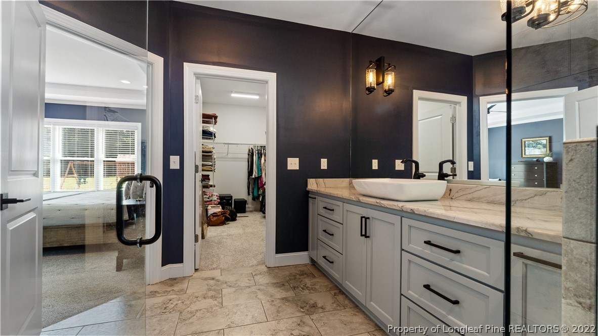 430 Mingo Church Road Dunn, NC 28334 - Photo 32 of 48 a bathroom with a granite countertop sink a vanity and a mirror