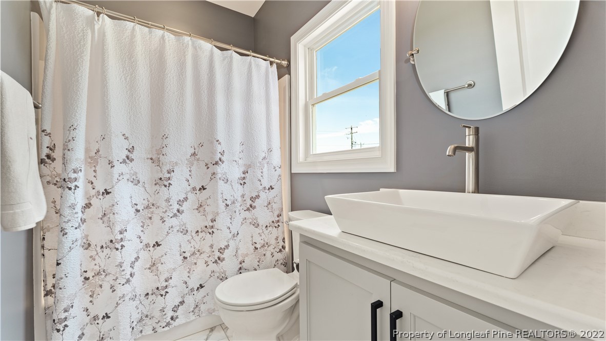 430 Mingo Church Road Dunn, NC 28334 - Photo 36 of 48 a white toilet sitting next to a bathroom sink