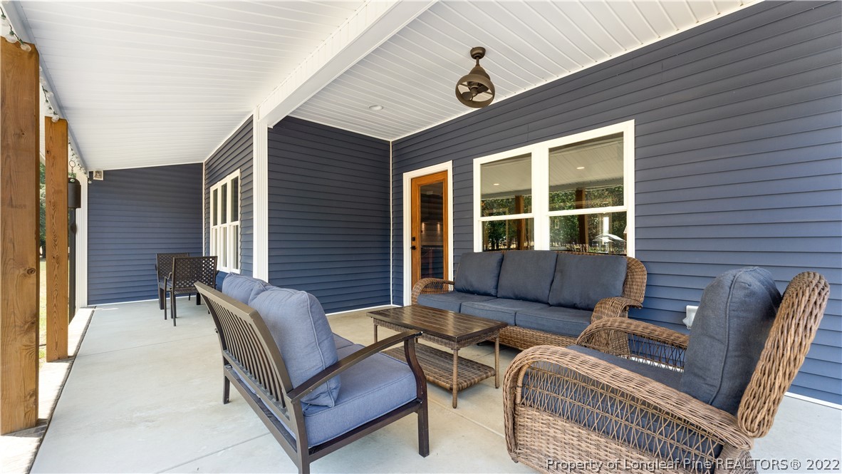 430 Mingo Church Road Dunn, NC 28334 - Photo 43 of 48 a view of a patio with couches and potted plant