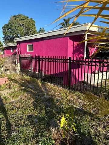a view of a house with a red gate