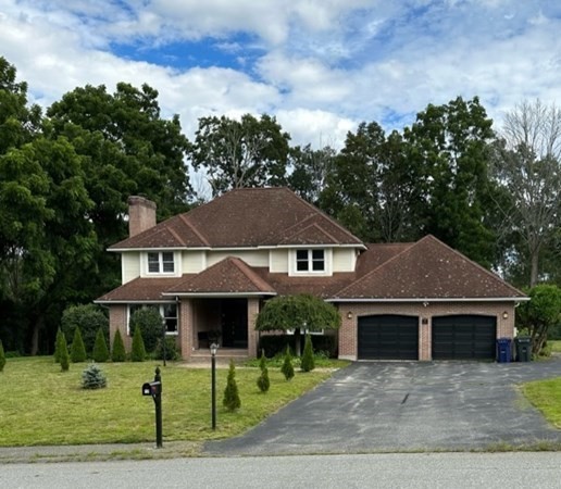 12 Hanson Lane Dracut, MA 01826 - Photo 1 of 23 a front view of a house with a garden