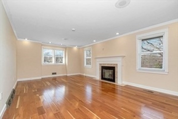 12 Hanson Lane Dracut, MA 01826 - Photo 11 of 23 an empty room with wooden floor fireplace and windows