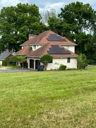 12 Hanson Lane Dracut, MA 01826 - Photo 2 of 23 a front view of a house with a garden