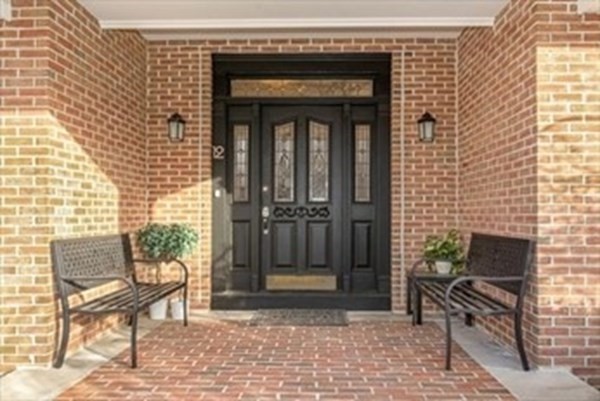 12 Hanson Lane Dracut, MA 01826 - Photo 4 of 23 a front view of a house with a chairs and table
